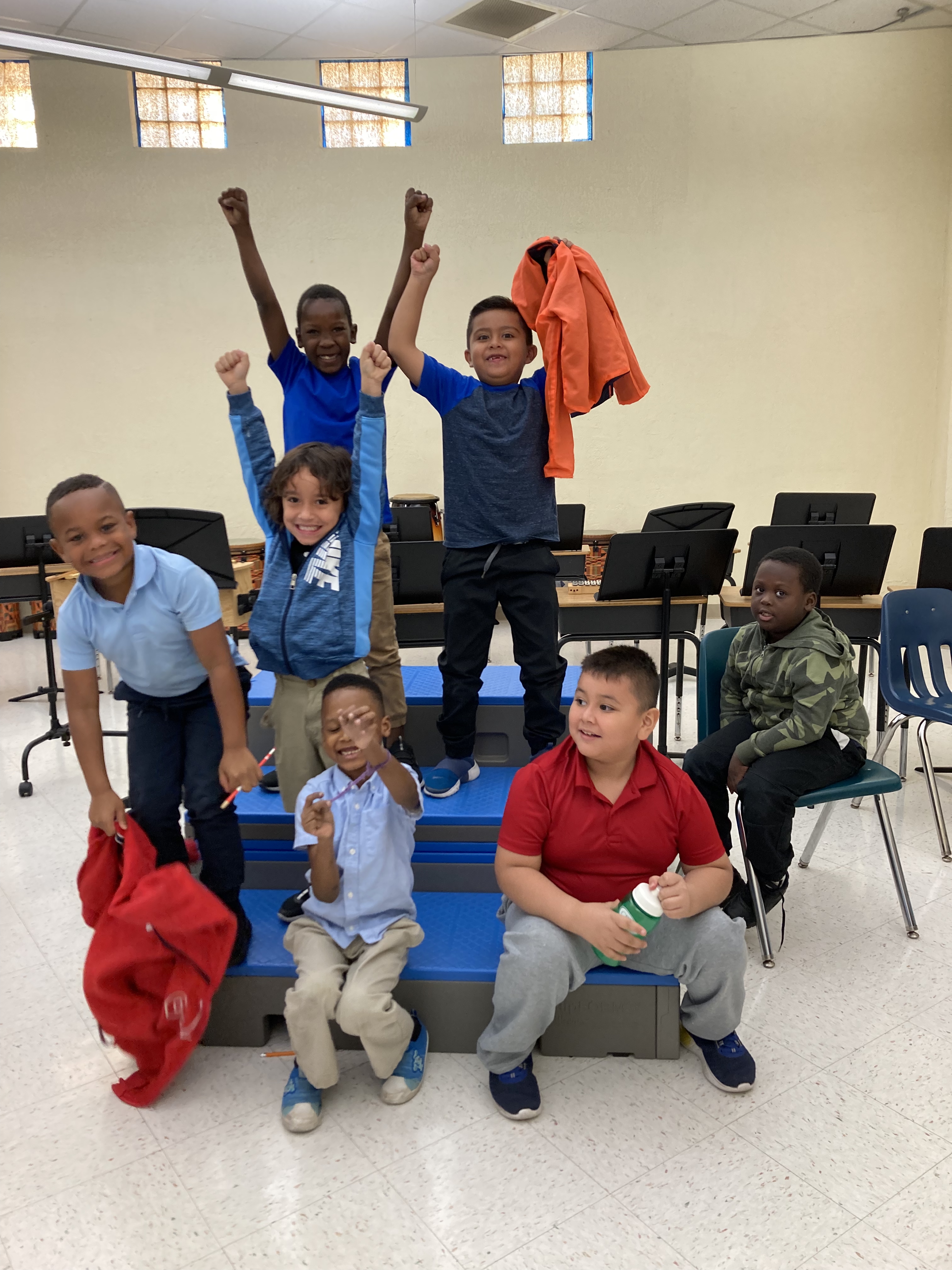 Group of students smiling together in music classroom